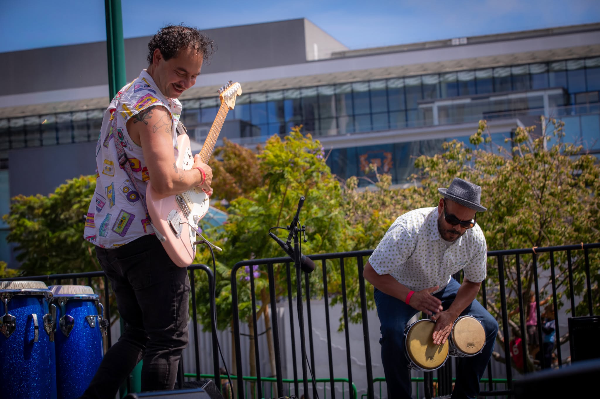 Guitar and hand percussion trading off on stage